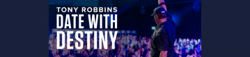 Background photo of Tony Robbins with his hands in the air and the date with destiny logo on the left side