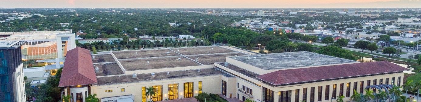 This is a photo of the front of the convention center from an aerial view looking down into the front entry and courtyard with a sunset sky background