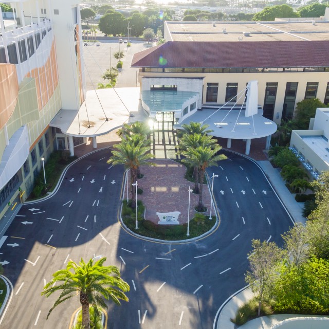 Exterior aerial shot hovering over the parking drive at the southeast entrance for the garage