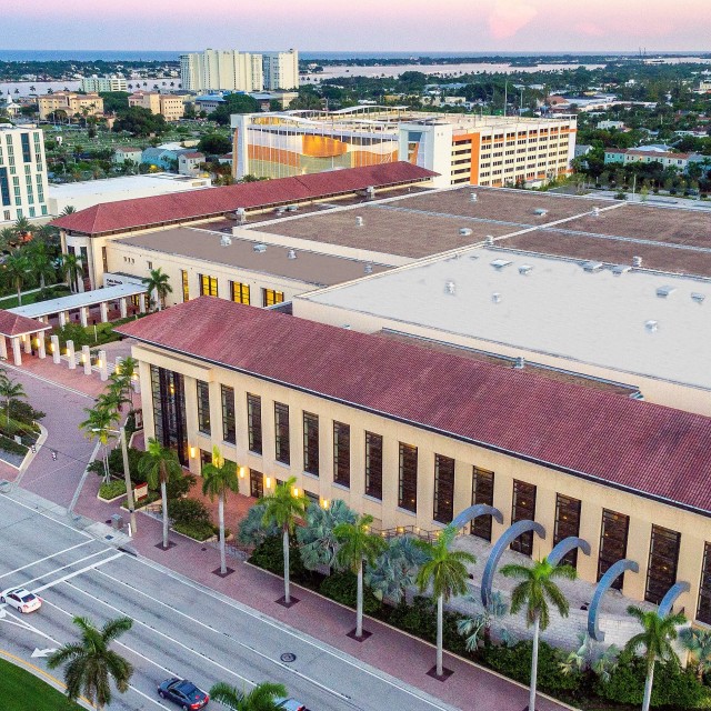 Exterior photo of low aerial view of the front of the main entrance and courtyard area