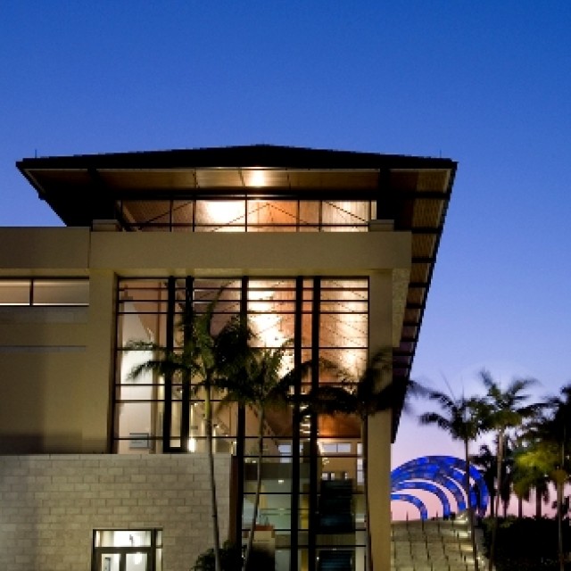 North side of building in evening with blue wave and ligths on