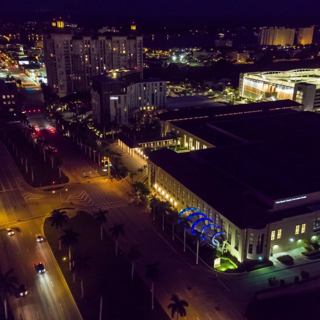 Exterior of entire building and downtown WPB during night aerial view