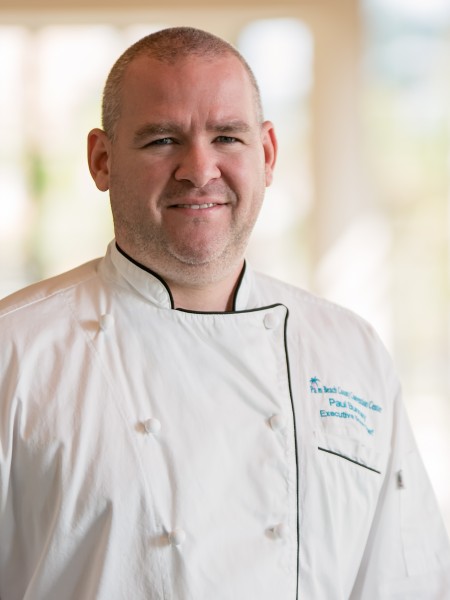 Photo Head shot of our Executive Chef Paul Bunney in a white chef's coat