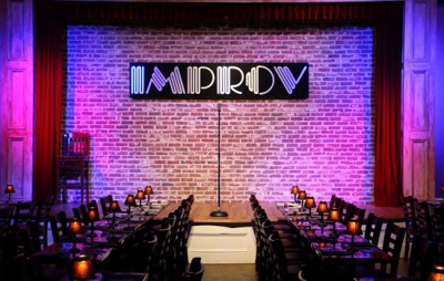 Photo of a view of the main stage with Improv sign in background. 
