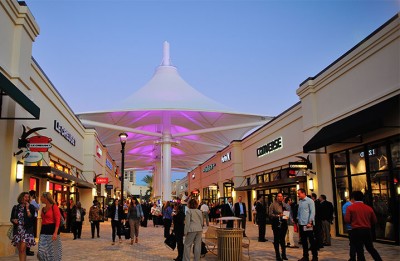 Photo of the Palm Beach outlets looking down an aisle where an awning covers the walkway