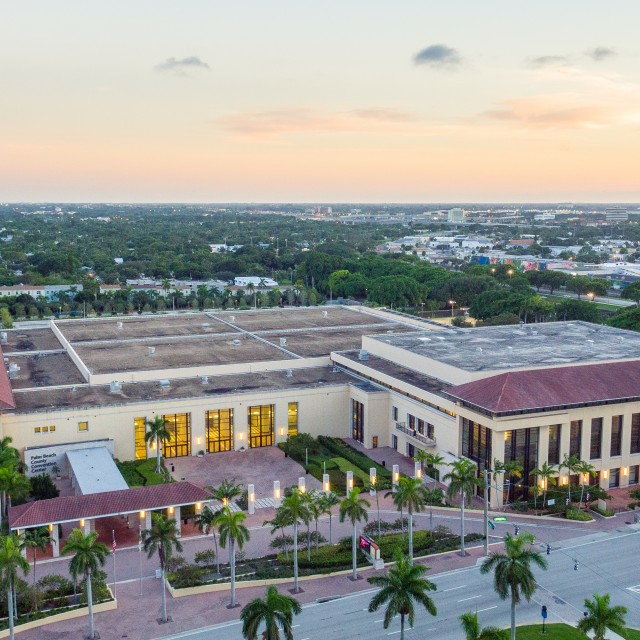Photo of Front aerial view of the building looking down with sunset in the background